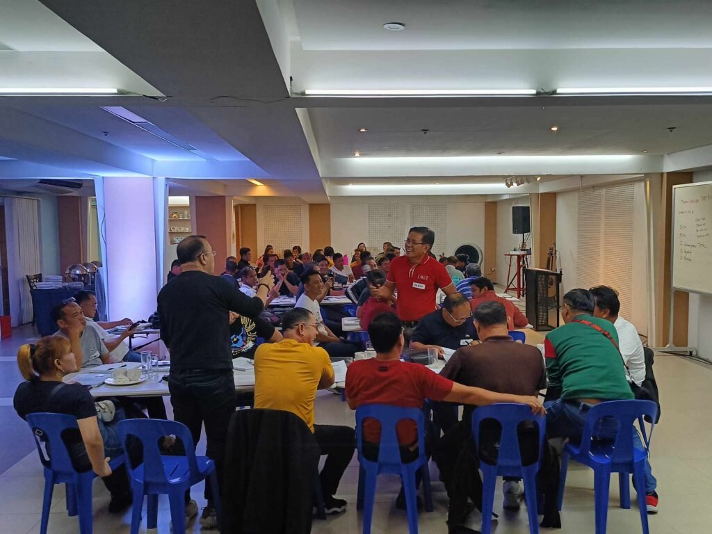 A group of people sitting around a table in a room.