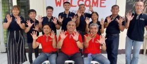A group of people in red shirts posing for a photo.