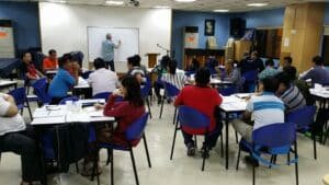 A group of people sitting at tables in a room.