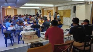 A group of people sitting at tables in a room.