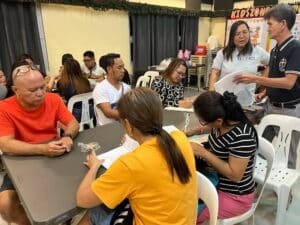 A group of people sitting at tables in a room.