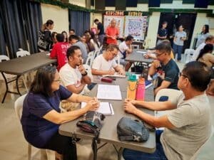 A group of people sitting at tables in a room.