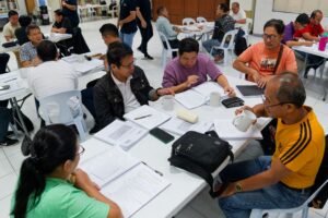 A group of people sitting at tables in a room.