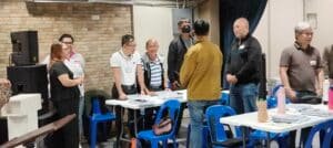 A group of people sitting at tables in a room.