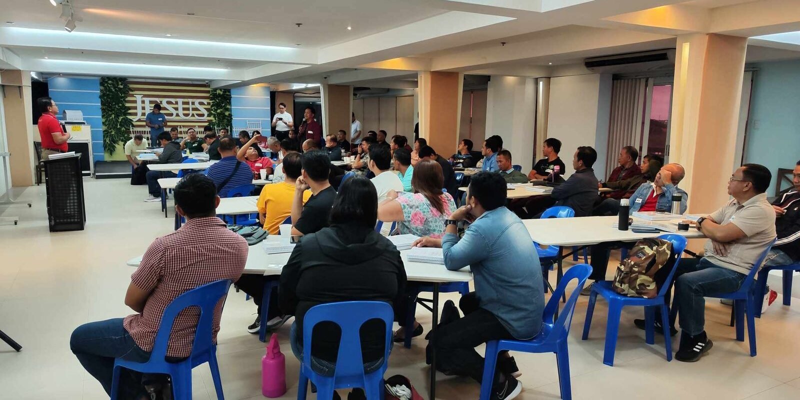 A group of people sitting at tables in a room.