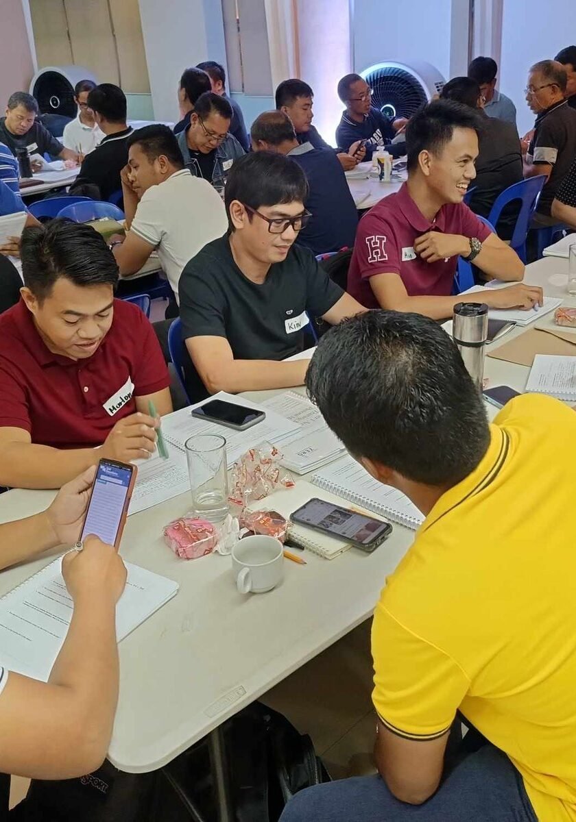 A group of people sitting around a table at a conference.